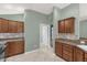 Bright kitchen features wooden cabinets, tiled floors and backsplash, and views to other rooms at 2568 Jupiter Way, The Villages, FL 32163
