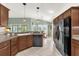 Open-concept kitchen with modern appliances and cabinetry adjacent to dining area at 2568 Jupiter Way, The Villages, FL 32163