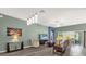 Bright living room with sliding glass doors to the lanai and view into the dining area at 2568 Jupiter Way, The Villages, FL 32163