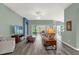 Sunlit living room offering seamless access to the outdoor lanai and featuring neutral-toned decor at 2568 Jupiter Way, The Villages, FL 32163