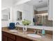 Bathroom showcasing double sinks, granite counters, a large mirror and updated lighting at 26822 Bull Run, Leesburg, FL 34748