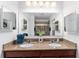 Bathroom showcasing double sinks, granite counters, a large mirror and updated lighting at 26822 Bull Run, Leesburg, FL 34748