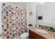Bathroom features a unique shower curtain, granite vanity, and tiled floor at 26822 Bull Run, Leesburg, FL 34748