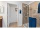 Open bathroom displays a sliding glass door shower and tiled floors at 26822 Bull Run, Leesburg, FL 34748