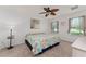 Bright bedroom has a ceiling fan and two windows, allowing natural light at 26822 Bull Run, Leesburg, FL 34748