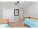 Bedroom features two twin beds, closet, and a ceiling fan at 26822 Bull Run, Leesburg, FL 34748
