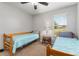 Bedroom features two twin beds, complemented by neutral walls and a window for natural light at 26822 Bull Run, Leesburg, FL 34748