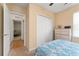 Bright bedroom features double door closet, with view to another room with bunk beds at 26822 Bull Run, Leesburg, FL 34748