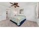 Bright bedroom featuring a ceiling fan, and a cozy bed with sea-themed quilt at 26822 Bull Run, Leesburg, FL 34748
