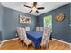 Comfortable dining room with large table, eight chairs, and a modern ceiling fan at 26822 Bull Run, Leesburg, FL 34748