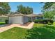 Attractive home with manicured lawn, established landscaping, and a convenient two-car garage at 26822 Bull Run, Leesburg, FL 34748
