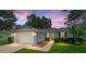 Charming single-story home featuring lush landscaping, well-manicured lawn and a two-car garage at 26822 Bull Run, Leesburg, FL 34748