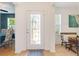 Bright entry foyer featuring decorative glass front door and tile flooring at 26822 Bull Run, Leesburg, FL 34748