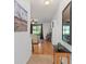 Hallway with hardwood floors leads to the living room and outdoor views at 26822 Bull Run, Leesburg, FL 34748