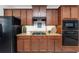 Contemporary kitchen featuring granite countertops and dark wooden cabinetry at 26822 Bull Run, Leesburg, FL 34748