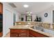 Bright kitchen featuring granite countertops, wooden cabinetry, and stainless steel sink and fixtures at 26822 Bull Run, Leesburg, FL 34748