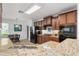Modern kitchen with granite countertops, stainless steel appliances, and dark wooden cabinets at 26822 Bull Run, Leesburg, FL 34748