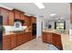 Open kitchen design featuring granite countertops, wooden cabinetry, and stainless steel appliances at 26822 Bull Run, Leesburg, FL 34748