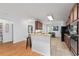Bright kitchen features wood cabinets, granite countertops, and barstool seating at 26822 Bull Run, Leesburg, FL 34748