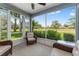 A screened lanai offering peaceful views with seating area to enjoy the scenery at 26822 Bull Run, Leesburg, FL 34748