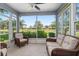 Relaxing screened porch with wicker seating and serene views at 26822 Bull Run, Leesburg, FL 34748