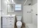 Clean bathroom with a white vanity, mirror, and tiled shower at 27610 Debbie Rd, Okahumpka, FL 34762