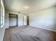 Neutral bedroom featuring carpeted floors, a walk-in closet, and convenient access to other rooms at 27610 Debbie Rd, Okahumpka, FL 34762