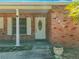 Close up of the front door of the home, with brick facade and address numbers at 27610 Debbie Rd, Okahumpka, FL 34762