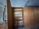 Spacious garage featuring built-in plywood shelving offering ample storage at 27610 Debbie Rd, Okahumpka, FL 34762