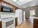 Efficient kitchen design with essential appliances and tiled floor at 27610 Debbie Rd, Okahumpka, FL 34762