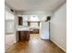 Traditional kitchen features wooden cabinets, a white refrigerator, and durable tile flooring at 27610 Debbie Rd, Okahumpka, FL 34762