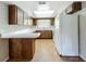Charming kitchen with wooden cabinets, bright skylight, and white appliances at 27610 Debbie Rd, Okahumpka, FL 34762