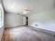 Expansive main bedroom features carpet flooring and a neutral color palette at 27610 Debbie Rd, Okahumpka, FL 34762