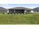 Spacious backyard features a well-maintained lawn with a screened in patio area, offering a private outdoor retreat at 2988 Sentell St, The Villages, FL 32163
