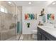 Contemporary bathroom features a tiled shower with glass door, a vanity, and stylish decor accents at 2988 Sentell St, The Villages, FL 32163