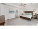 Bright bedroom features a ceiling fan, wood furniture, and an ensuite bathroom for added convenience at 2988 Sentell St, The Villages, FL 32163