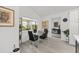 Bright dining area with a modern glass table and views of the backyard through a large window at 2988 Sentell St, The Villages, FL 32163
