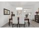 Bright dining room with modern lighting, decor, and wood-look floors, perfect for Gathering meals at 2988 Sentell St, The Villages, FL 32163