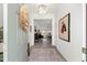Inviting entryway featuring a decorative rug, stylish lighting, and a view into the open-concept living area at 2988 Sentell St, The Villages, FL 32163