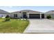 Beautiful single-Gathering home with a well-maintained lawn, three-car garage, and tastefully landscaped front yard at 2988 Sentell St, The Villages, FL 32163