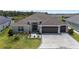Aerial view of a beautiful single-Gathering home with three-car garage, and a well-manicured lawn at 2988 Sentell St, The Villages, FL 32163
