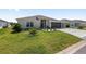 Beautiful single-Gathering home with a well-maintained lawn, three-car garage, and tastefully landscaped front yard at 2988 Sentell St, The Villages, FL 32163