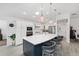 Beautiful kitchen with stainless steel appliances, large island with barstool seating, and modern pendant lighting at 2988 Sentell St, The Villages, FL 32163