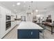 Modern kitchen featuring a center island with a bar, stainless steel appliances and recessed lighting at 2988 Sentell St, The Villages, FL 32163