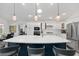 Bright kitchen featuring a large island with seating and sink, stainless steel appliances, and pendant lights at 2988 Sentell St, The Villages, FL 32163