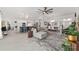 Open-concept living room featuring a neutral color scheme, modern furnishings, and seamless flow to the kitchen at 2988 Sentell St, The Villages, FL 32163