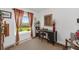 Cozy office space with natural light, desk, view of the yard, and red accent curtains at 2988 Sentell St, The Villages, FL 32163