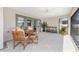 Covered outdoor patio with dining furniture and view of the landscaped backyard at 2988 Sentell St, The Villages, FL 32163