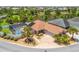 Beautiful aerial shot of a home with a screened pool and lush landscaping in a quiet, friendly neighborhood at 2998 Kramer Ct, The Villages, FL 32163