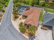 Aerial view of a single-story home with a screened-in pool, well-manicured lawn, and attached garage in a golf community at 2998 Kramer Ct, The Villages, FL 32163